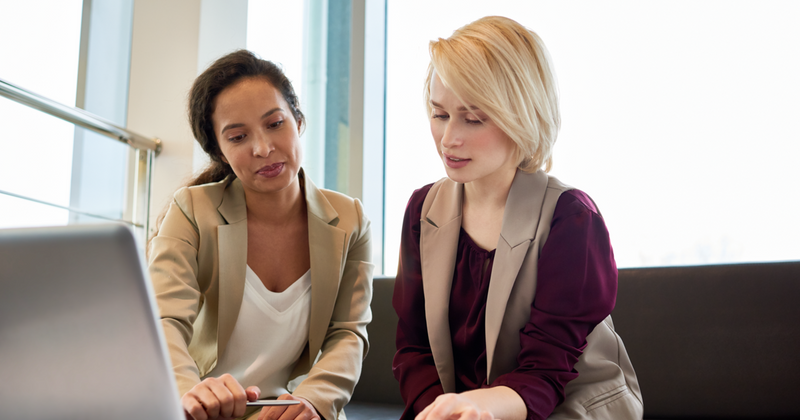 Two women discussing finances.